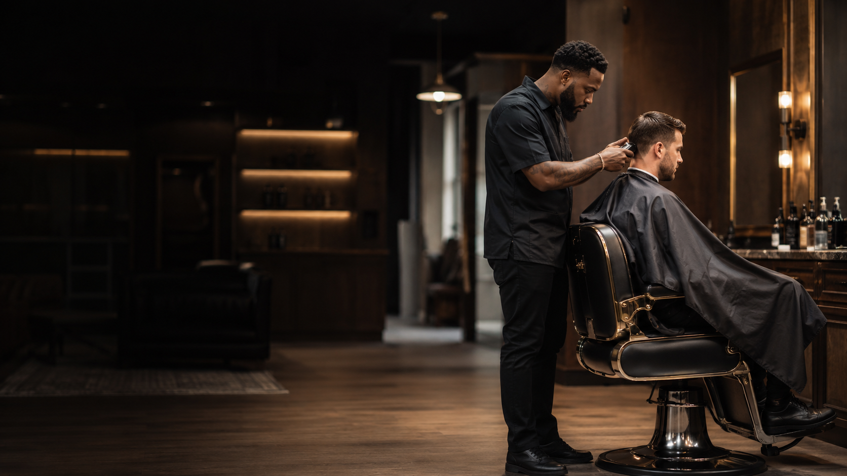 Professional barber giving a client a fade in an upscale barbershop